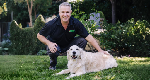 Carl Peterson CEO of Bark Busters Home Dog Training with a Golden Retriever