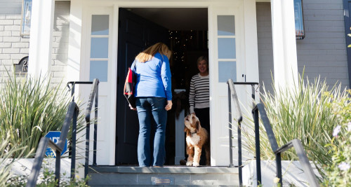 Dog trainer arrives at clients home for dog training lesson