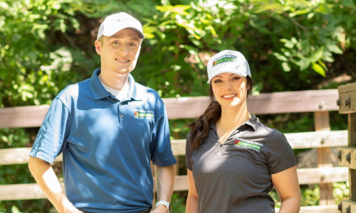 Dog training couple out for a walk on a sunny day