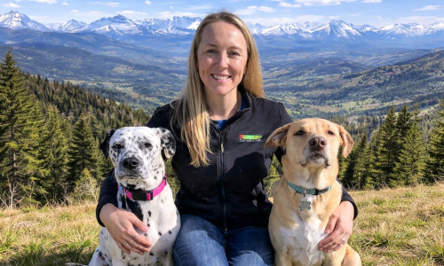 Bark Busters dog trainer with two dogs in the Colorado mountains
