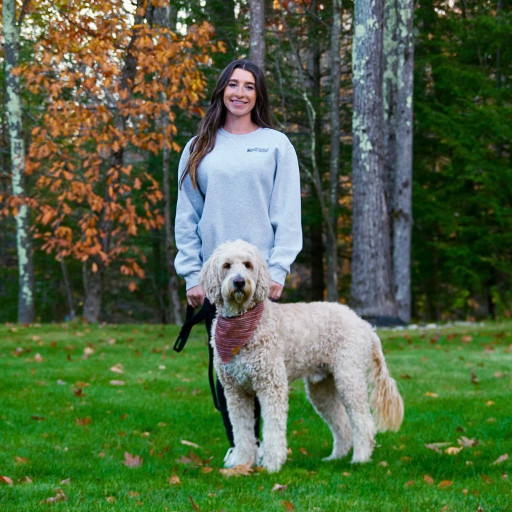 Dog trainer with her dog in Boston autumn foliage