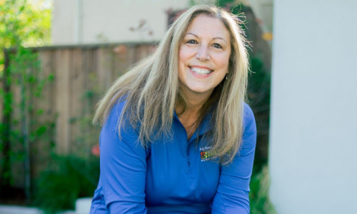 Professional dog trainer training a puppy in the backyard