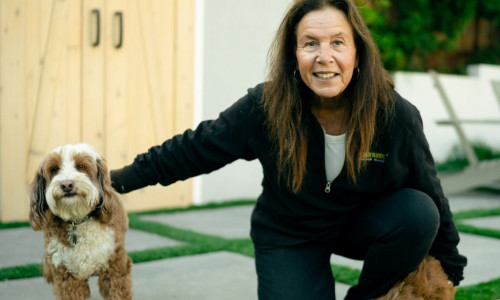 Dog trainer with two puppies in the backyard
